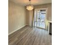 Bright dining room with sliding glass doors to the backyard and decorative lighting at 7144 Forest Vista St, Las Vegas, NV 89147