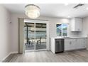 Kitchen features stainless steel appliances and backyard access through sliding glass door at 7144 Forest Vista St, Las Vegas, NV 89147