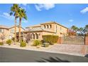 Charming two-story home with a well-maintained front yard and gated driveway, showcasing curb appeal at 7258 Sashaying Spirit Ct, Las Vegas, NV 89131