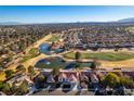 Serene aerial view showcasing lush golf course, community, and nearby mountain views at 8713 Litchfield Ave, Las Vegas, NV 89134