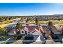 Aerial view showcases a well-maintained home adjacent to a scenic golf course with lush landscaping and water features at 8713 Litchfield Ave, Las Vegas, NV 89134