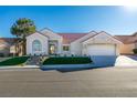 Charming single-story home with a well-manicured lawn, elegant front entrance, and a spacious driveway leading to the garage at 8713 Litchfield Ave, Las Vegas, NV 89134