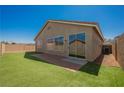 A view of the backyard, showing the patio and fencing at 909 Trinity Pond Cir, Henderson, NV 89002