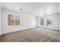 Bright bedroom with neutral carpet, crown molding, and large windows allowing lots of natural light at 9146 Grand Sunburst Ct, Las Vegas, NV 89149