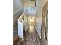 Inviting entryway with wood-look flooring, staircase, and neutral paint at 9165 Beauchamp Ave, Las Vegas, NV 89148