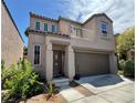 Two-story home featuring a balcony, stucco siding, and a two-car garage at 9165 Beauchamp Ave, Las Vegas, NV 89148