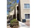 Close-up of the building exterior, showcasing the walkways, stairs, and landscaping at 9470 Peace Way # 212, Las Vegas, NV 89147