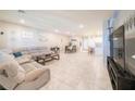 Spacious living room with tile floors, neutral colors, and ample seating at 3220 Mckenna Dawn Ave, Henderson, NV 89044