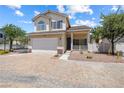 Inviting two-story home with a brick driveway, manicured landscaping, and a cozy front porch area at 10348 Cherry Brook St, Las Vegas, NV 89183