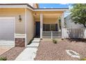 Close-up of the covered front porch with white railing, a desert landscape, and an exterior light fixture at 10348 Cherry Brook St, Las Vegas, NV 89183