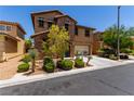 Charming two-story home featuring a stone facade, well-manicured landscaping, and an attached two-car garage at 10584 Peach Creek St, Las Vegas, NV 89179