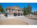 Two-story home featuring a balcony and a charming, landscaped yard with gravel and mature trees at 1106 E Athens Ave, Henderson, NV 89015