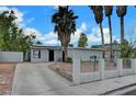 Single-story home with desert landscaping, a driveway and block fence at 1804 David Ave, Las Vegas, NV 89101