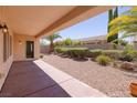 A covered back patio with desert landscaping and privacy wall at 2131 Waterton Rivers Dr, Henderson, NV 89044