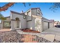 Beautiful two-story house with a red tile roof, arched entryway, and manicured landscaping at 2204 W San Miguel Ave, North Las Vegas, NV 89032
