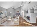 Bright living room with high ceilings, a cozy fireplace, and modern furnishings at 2204 W San Miguel Ave, North Las Vegas, NV 89032