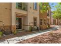 View of the side of the condo with a covered patio and well-maintained landscaping at 224 Morgyn Ln # 6, Boulder City, NV 89005
