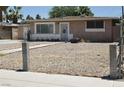 View of a single-story home featuring a gravel front yard and a walkway to the front door at 2616 Spear St, North Las Vegas, NV 89030