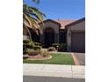 Charming front entrance featuring a meticulously landscaped yard and decorative security door at 2695 Olivia Heights Ave, Henderson, NV 89052