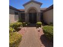 Eye-level view of a stylish front entrance showcasing a decorative security door and manicured landscaping at 2695 Olivia Heights Ave, Henderson, NV 89052
