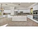 Well-lit kitchen featuring white cabinetry, stainless steel appliances, granite countertops, and tile flooring at 37 Stonemark Dr, Henderson, NV 89052