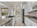 Modern kitchen includes granite countertops, stainless steel appliances, and ample cabinet space at 37 Stonemark Dr, Henderson, NV 89052