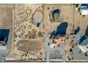 Expansive aerial view of property with horse facilities, paddocks, and desert landscape at 3821 Tumbleweed Ave, Pahrump, NV 89048