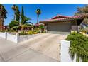 Inviting single-story home showcasing a concrete driveway, two-car garage, and manicured desert landscaping at 3826 Edmond St, Las Vegas, NV 89103