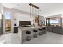 Modern kitchen with a large island, bar seating, and sleek appliances, perfect for cooking and entertaining guests at 387 Solitude Peak Ln, Henderson, NV 89012