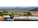 Expansive view from the patio, overlooking the city skyline and lush green landscape, offering serene outdoor living at 387 Solitude Peak Ln, Henderson, NV 89012