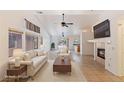 Bright living room with vaulted ceiling, fireplace, and tiled floors provides an airy open space at 4043 Lilac Creek Ct, Las Vegas, NV 89122