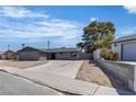 Street view of a single-story home featuring a long driveway and mature shade tree at 4272 Sheppard Dr, Las Vegas, NV 89121