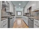 Galley kitchen with stainless steel appliances, light countertops, and sleek cabinetry at 4272 Sheppard Dr, Las Vegas, NV 89121