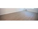 A view of the light-colored wood-look floors in the light and bright living room at 4600 University Center Dr # 72, Las Vegas, NV 89119