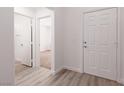 Bright entryway featuring wood-look flooring, white walls, and access to other rooms at 5049 Running Rapids Ave, Las Vegas, NV 89130