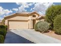 Inviting single-story home featuring a well-maintained front yard and a two-car garage at 5049 Running Rapids Ave, Las Vegas, NV 89130