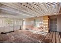Covered outdoor patio featuring patterned concrete flooring and a lattice-covered wall for added privacy at 5121 Gains Mill St, Las Vegas, NV 89122
