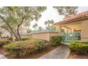 Community pool area with lush landscaping, secure fencing, and a covered area at 5415 W Harmon Ave # 1162, Las Vegas, NV 89103