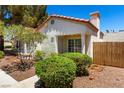 Charming single-story home with a terracotta roof, landscaped yard, and decorative gate at 5424 Geneive Ln # 105, Las Vegas, NV 89108