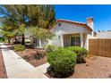 Charming single-story home with a terracotta roof, landscaped yard, and decorative gate at 5424 Geneive Ln # 105, Las Vegas, NV 89108