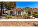 Charming single-story home with a terracotta roof, bay windows, and xeriscaped landscaping at 5424 Geneive Ln # 105, Las Vegas, NV 89108