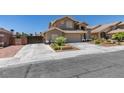 Charming home with landscaped front yard, desert landscaping, attached garage and additional gated parking on the side of the house at 6109 Sandstone Mesa Dr, Las Vegas, NV 89130