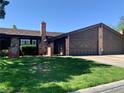 Charming single-story home with brick accents, a well-manicured lawn, and a two car garage at 6441 Brushwood Ln, Las Vegas, NV 89107
