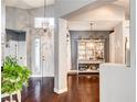 Inviting home foyer featuring hardwood floors and decorative light fixtures, leads into main living areas at 703 Jane Eyre Pl, Henderson, NV 89002