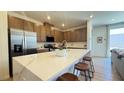 Modern kitchen featuring a large island with seating, stainless steel appliances, and quartz countertops at 739 Wild Highlands Ln, Henderson, NV 89015