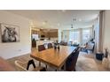 Open-concept living and dining area with hardwood floors and lots of natural light at 739 Wild Highlands Ln, Henderson, NV 89015