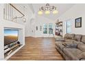Bright living room with vaulted ceilings, wood floors, and a cozy seating area, creating a welcoming and stylish space at 741 Wildwood Beach Ave, Henderson, NV 89052