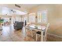 Cozy dining area off living room features modern table, tile floors, and plantation shutters at 7450 S Eastern Ave # 1058, Las Vegas, NV 89123
