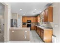 Functional kitchen with ample cabinets, stainless steel appliances, and breakfast bar at 7818 Brodie Castle Ct, Las Vegas, NV 89166