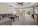 Open-concept living area featuring tiled floors, neutral paint, and access to the backyard at 7818 Brodie Castle Ct, Las Vegas, NV 89166
